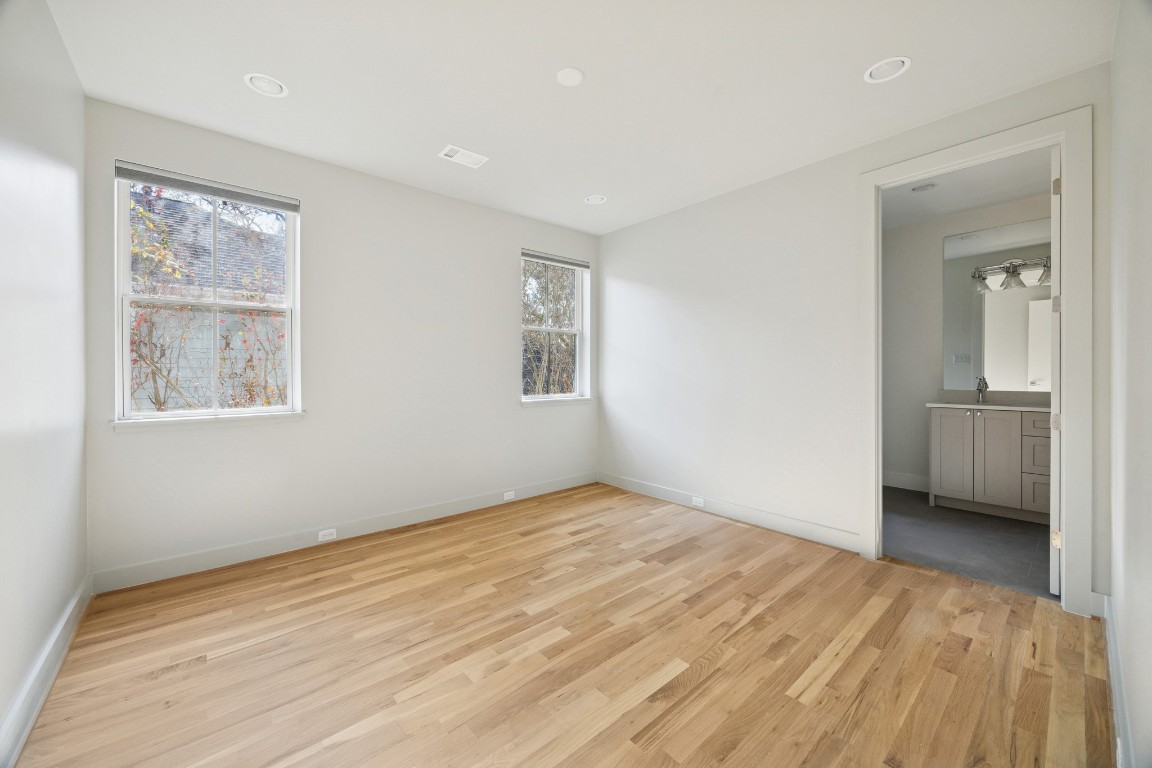 4219 Alba Road Houston, TX 77018 - Photo 28 of 39 Spacious bedroom featuring hardwood flooring, recessed lighting, and direct access to a private en-suite bathroom.
