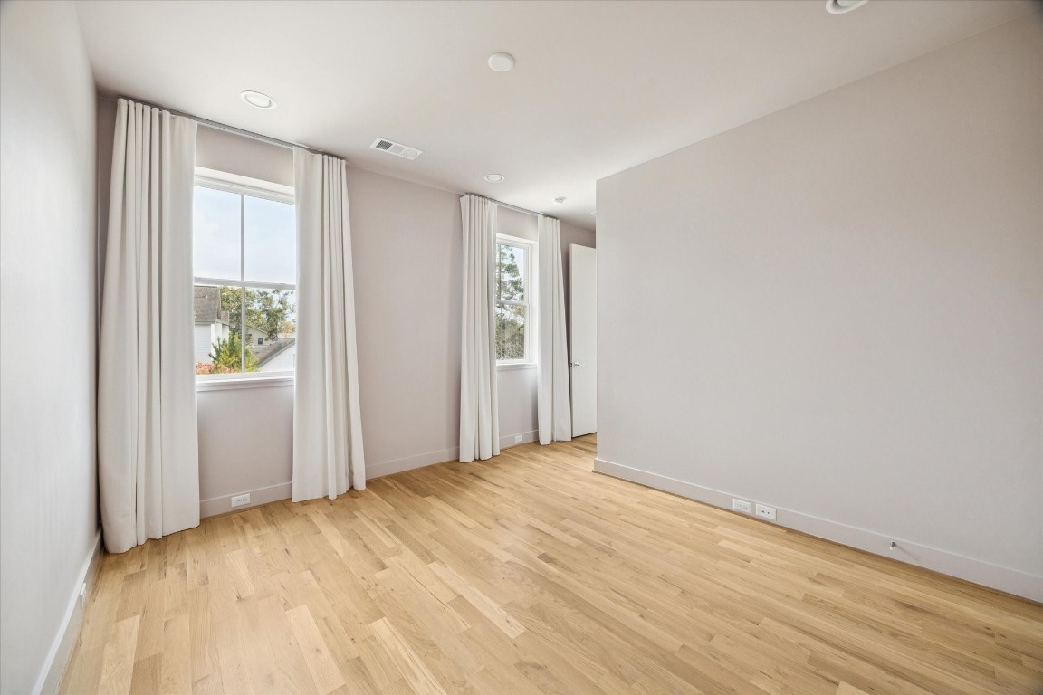 4219 Alba Road Houston, TX 77018 - Photo 29 of 39 Well-proportioned bedroom with hardwood floors, recessed lighting, and large windows providing abundant natural light.