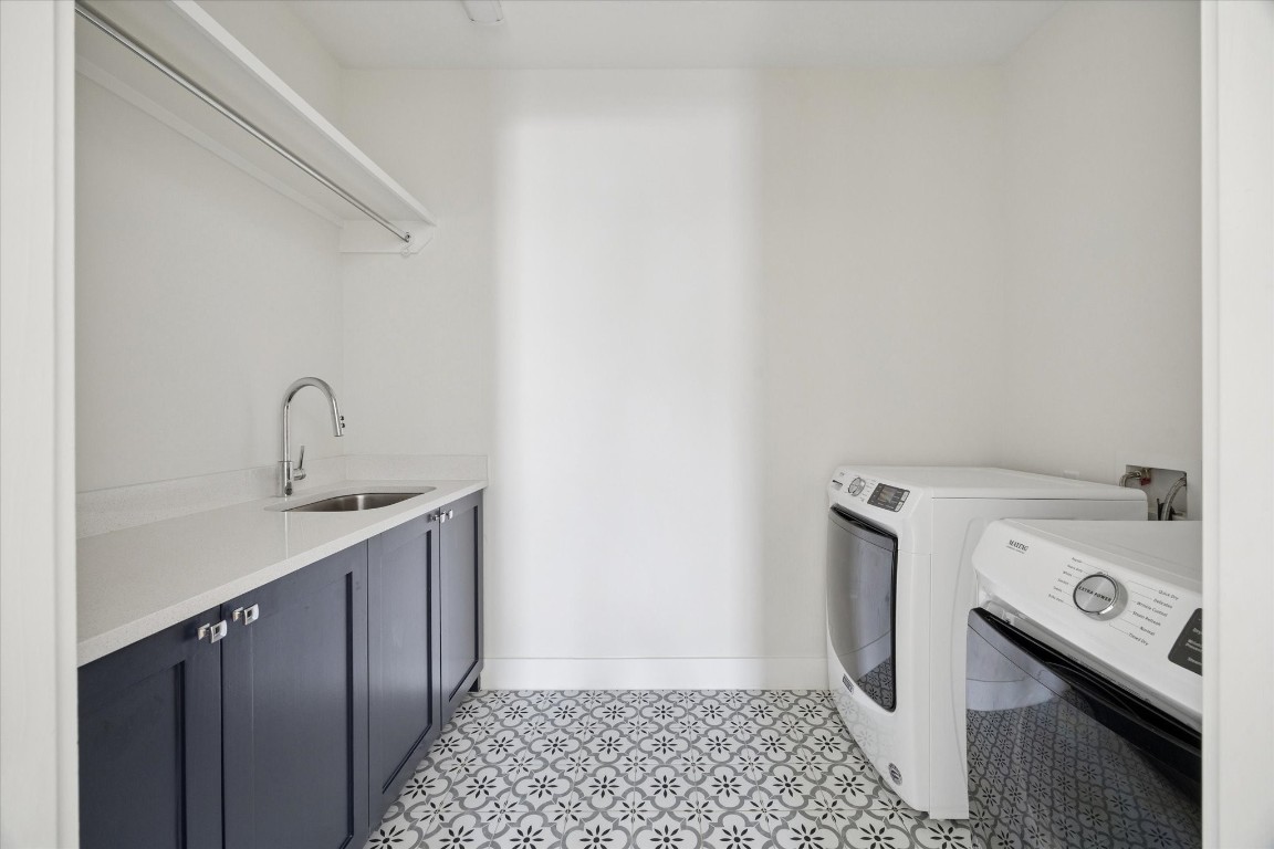 4219 Alba Road Houston, TX 77018 - Photo 33 of 39 Well-appointed utility room with custom cabinetry, quartz countertop, utility sink, patterned tile flooring, and space for full-size washer and dryer.