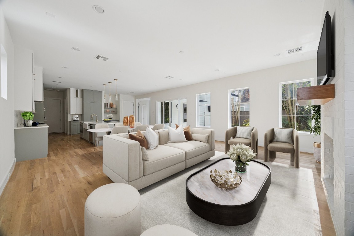 4219 Alba Road Houston, TX 77018 - Photo 5 of 39 Expansive open-concept living space with wide-plank hardwood floors, abundant natural light, and sightlines to the kitchen and outdoor areas. *virtually staged*