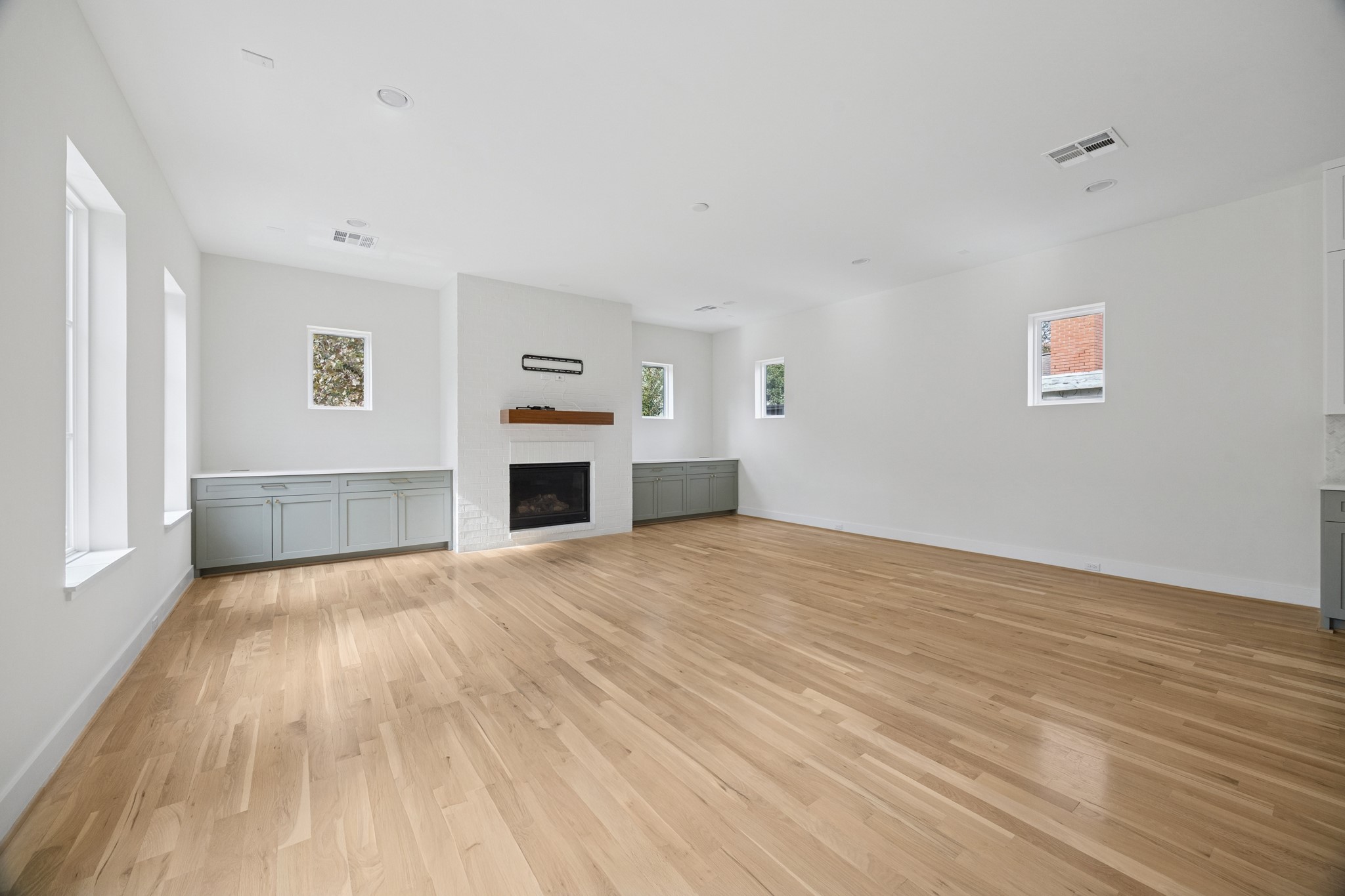 4219 Alba Road Houston, TX 77018 - Photo 6 of 39 a view of empty room with wooden floor and fireplace