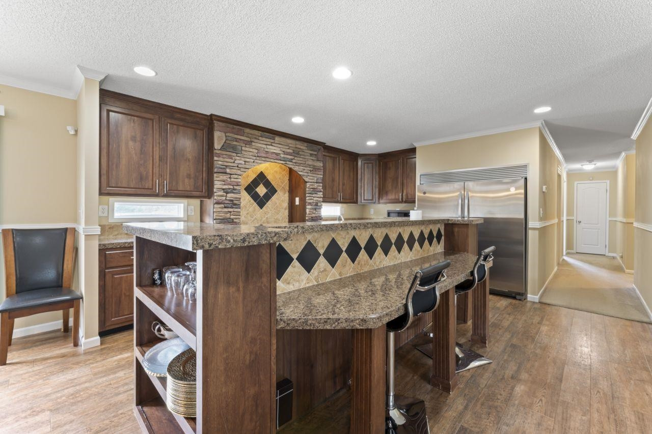 161 Mulchi Road Norlina, NC 27563 - Photo 18 of 38 a kitchen with stainless steel appliances granite countertop a refrigerator a stove and a wooden cabinets with wooden floor
