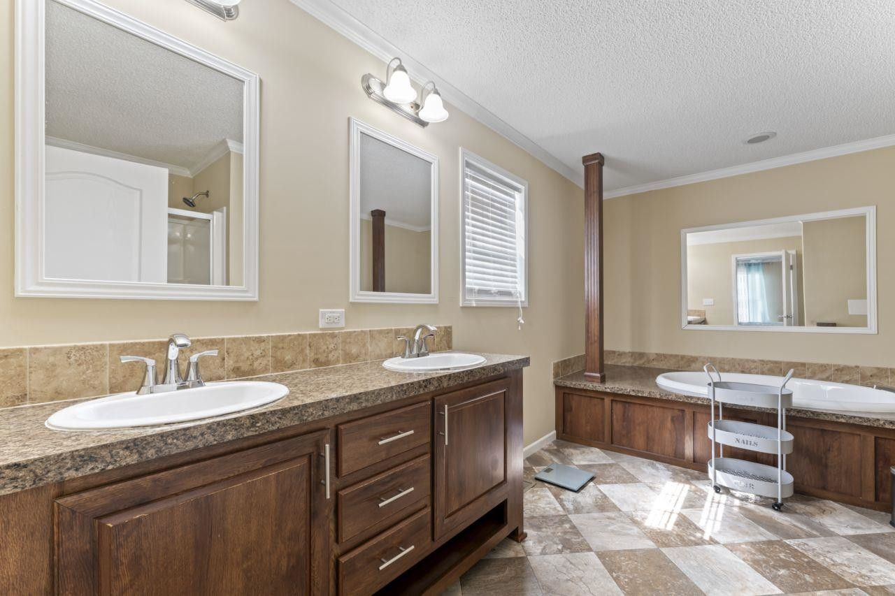 161 Mulchi Road Norlina, NC 27563 - Photo 30 of 38 a bathroom with a granite countertop sink double vanity granite tub and a mirror