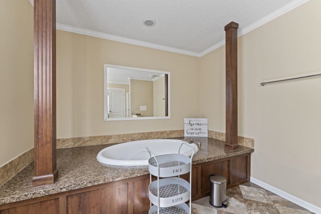 161 Mulchi Road Norlina, NC 27563 - Photo 31 of 38 a bathroom with a granite countertop sink a mirror and a toilet