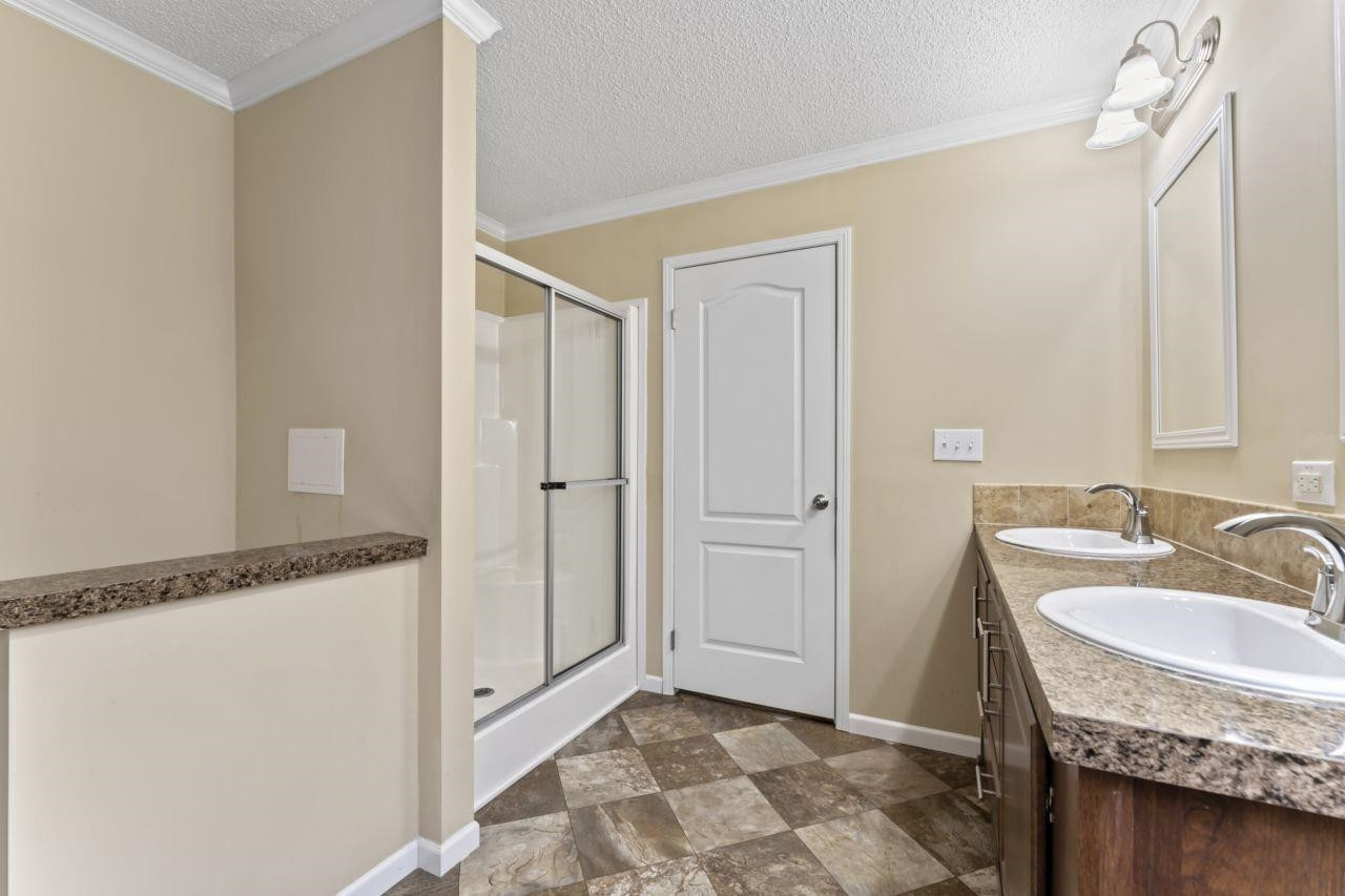 161 Mulchi Road Norlina, NC 27563 - Photo 32 of 38 a bathroom with a granite countertop sink and a mirror