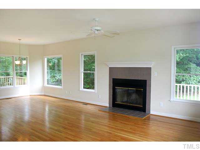 3225 Henderson Field Road Mebane, NC 27302 - Photo 4 of 21 Lots of windows throughout. Here is a view from the front end of the Family Room, showing the tiled Fireplace and looking into the Dining Room.