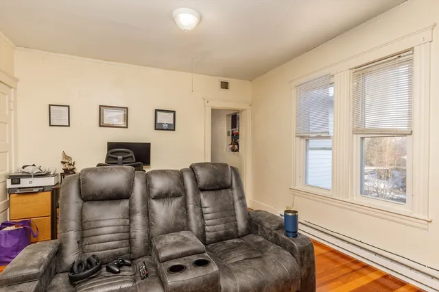 a bedroom with a bed and large windows