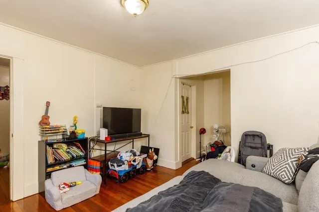 a bedroom with a bed and dresser with mirror