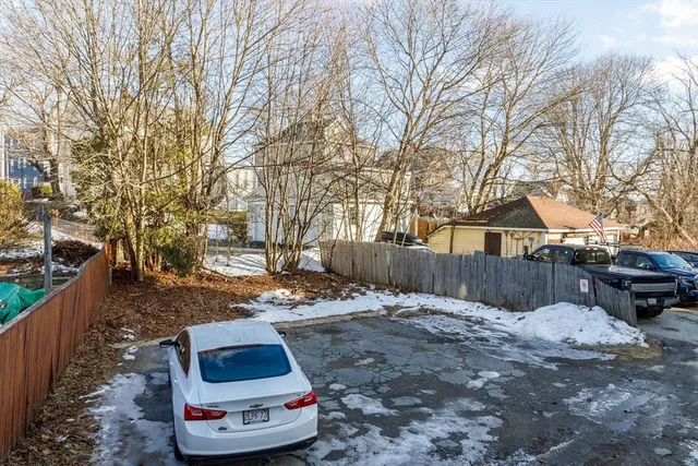 a view of a room with wooden floor and a window