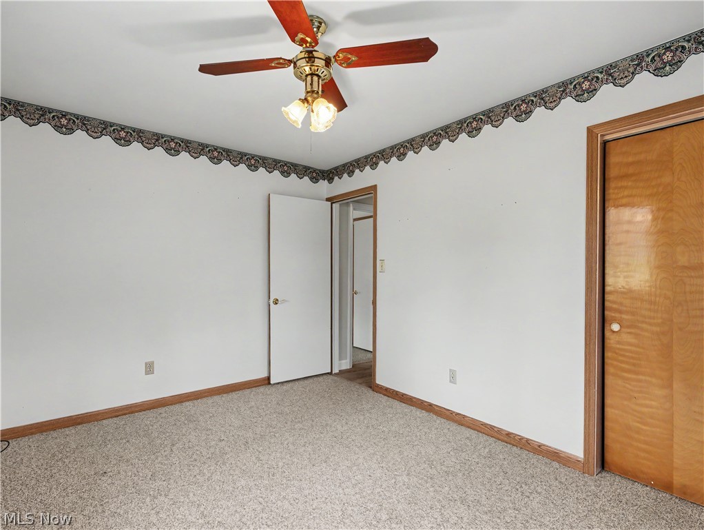 8406 Whipporwill Road Ravenna, OH 44266 - Photo 23 of 26 Bedroom with ceiling fan, carpet and closet.