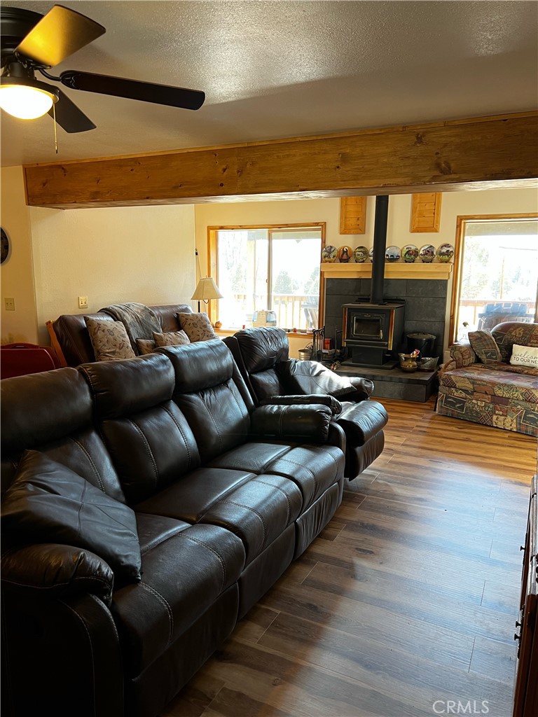 98443 Sierra Meadow Road Inyokern, CA 93527 - Photo 16 of 62 a living room with furniture and a fireplace