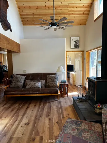 a room with a table chairs and a refrigerator