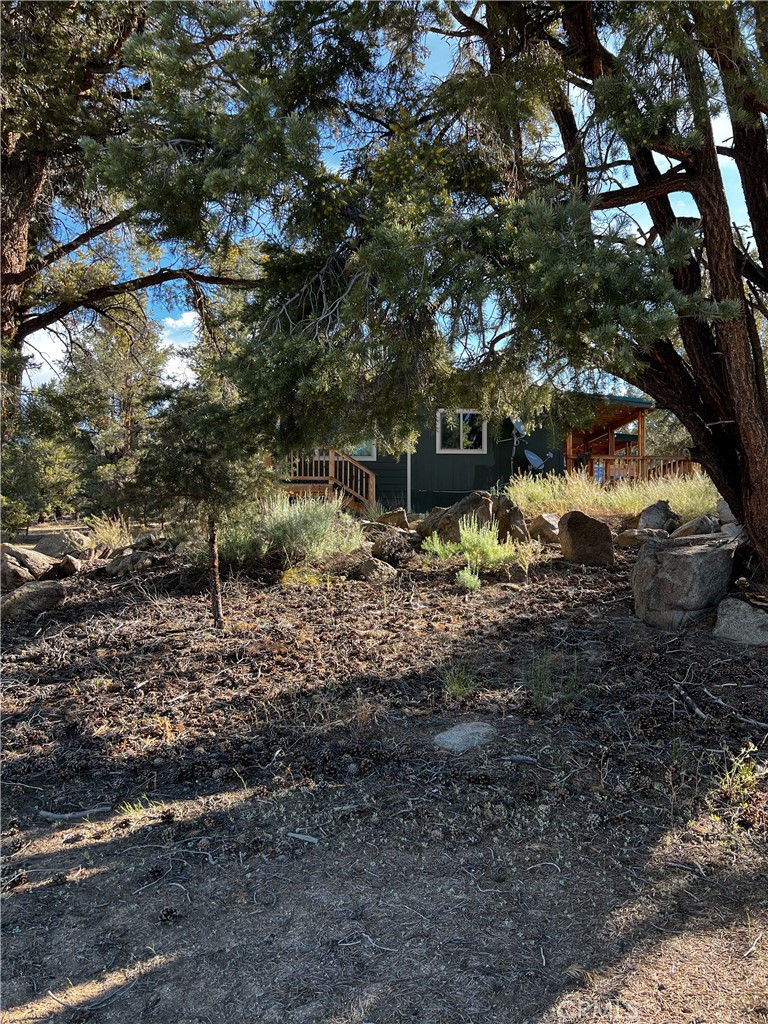 98443 Sierra Meadow Road Inyokern, CA 93527 - Photo 44 of 62 a backyard of a house with lots of green space