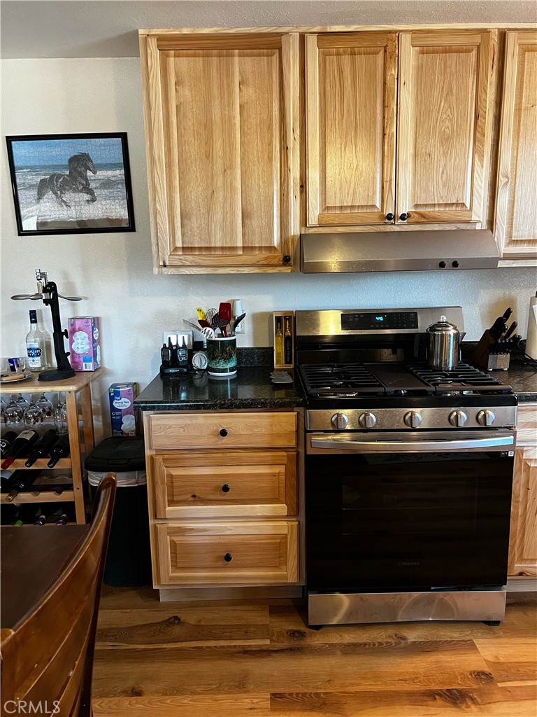 98443 Sierra Meadow Road Inyokern, CA 93527 - Photo 9 of 62 a kitchen with stainless steel appliances granite countertop a stove and a refrigerator