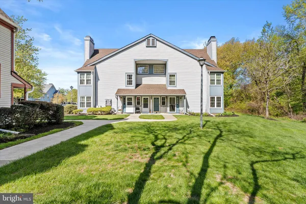 a front view of a house with yard and green space