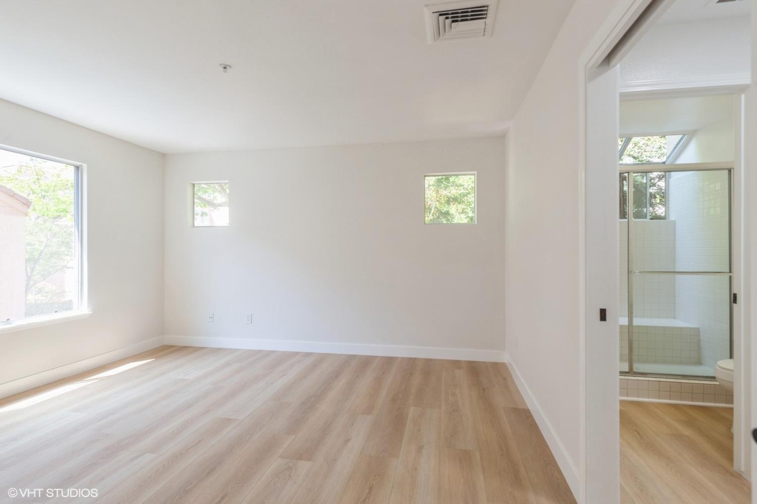 987 Asilomar Terrace, Unit 2 Sunnyvale, CA 94086 - Photo 11 of 48 an empty room with wooden floor and windows