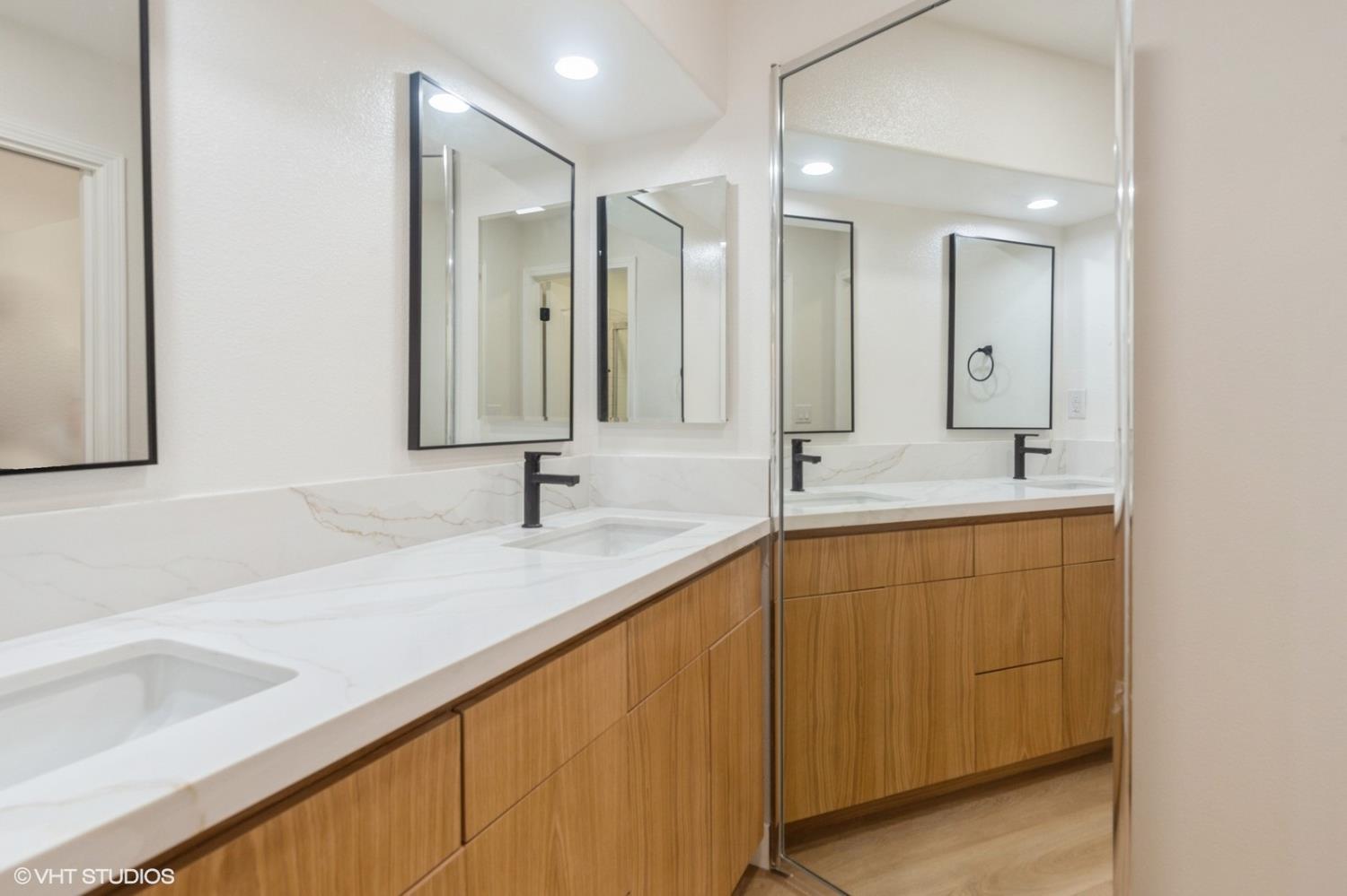 987 Asilomar Terrace, Unit 2 Sunnyvale, CA 94086 - Photo 13 of 48 a bathroom with double sink and a mirror