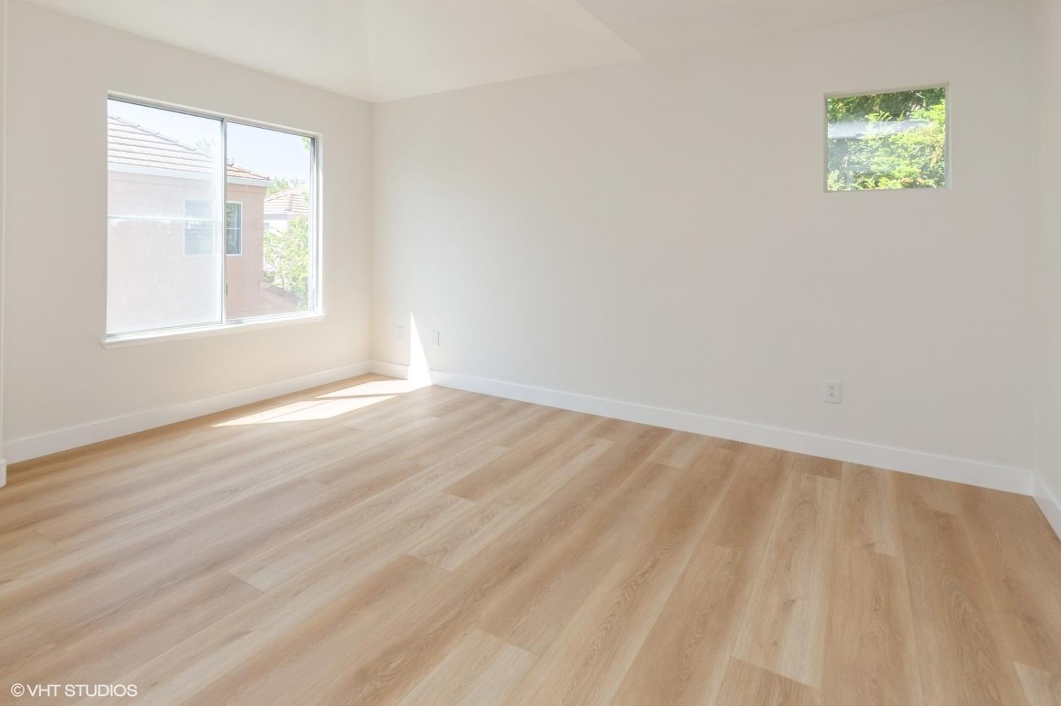 987 Asilomar Terrace, Unit 2 Sunnyvale, CA 94086 - Photo 17 of 48 wooden floor in an empty room with a window