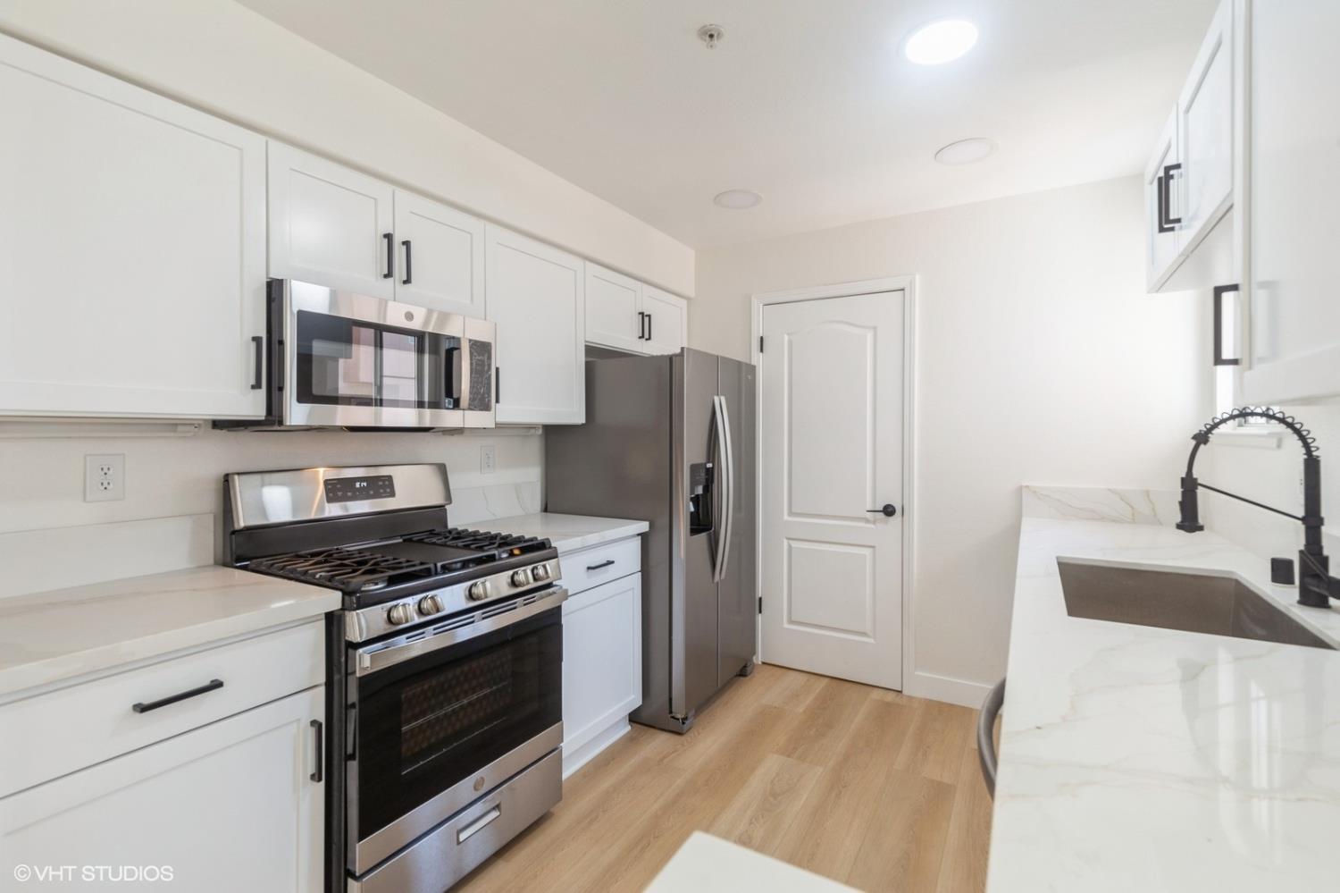 987 Asilomar Terrace, Unit 2 Sunnyvale, CA 94086 - Photo 21 of 48 a kitchen with stainless steel appliances a refrigerator stove and microwave