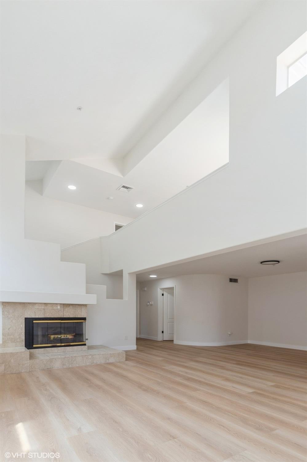 987 Asilomar Terrace, Unit 2 Sunnyvale, CA 94086 - Photo 23 of 48 a view of an empty room with wooden floor and a window