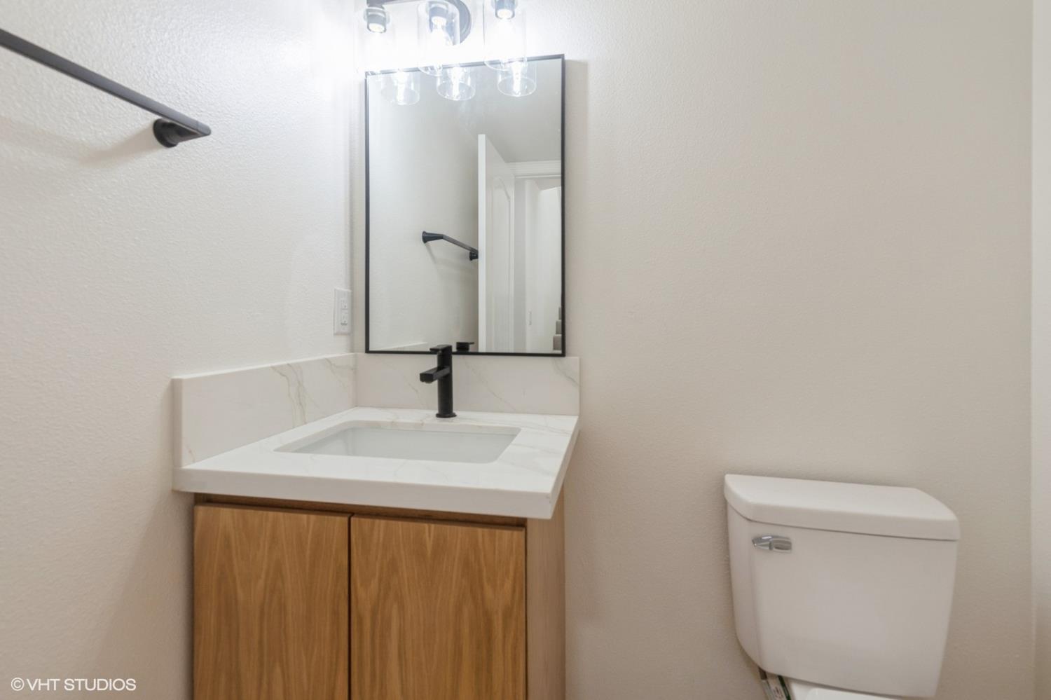 987 Asilomar Terrace, Unit 2 Sunnyvale, CA 94086 - Photo 28 of 48 a bathroom with a sink a toilet and mirror