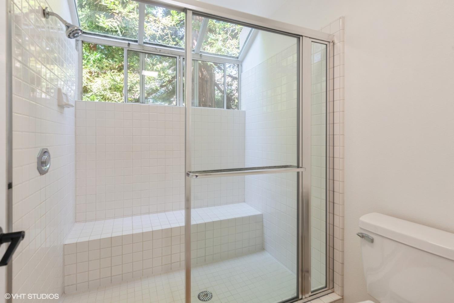 987 Asilomar Terrace, Unit 2 Sunnyvale, CA 94086 - Photo 35 of 48 a bathroom with a glass shower door