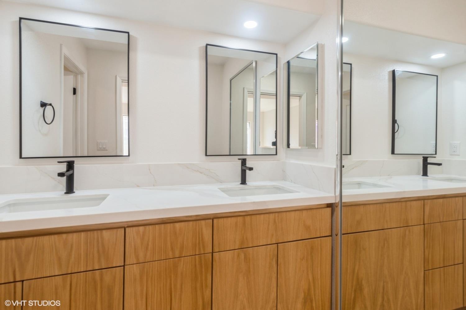 987 Asilomar Terrace, Unit 2 Sunnyvale, CA 94086 - Photo 39 of 48 a bathroom with a double vanity sink and a mirror