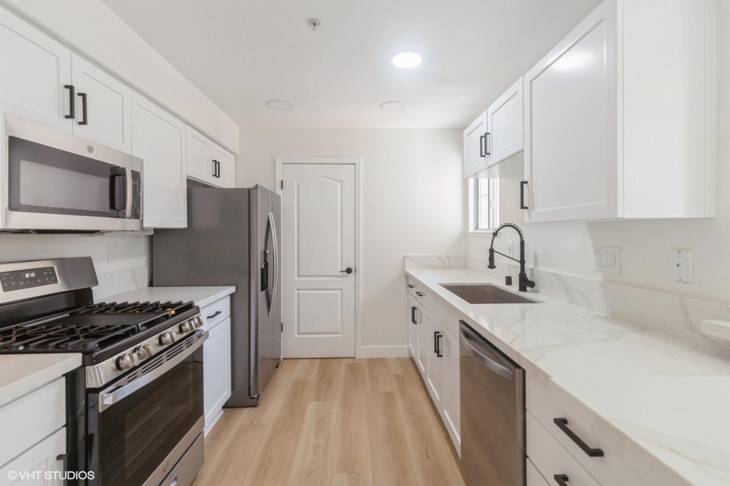 987 Asilomar Terrace, Unit 2 Sunnyvale, CA 94086 - Photo 9 of 48 a kitchen with a sink stove and refrigerator