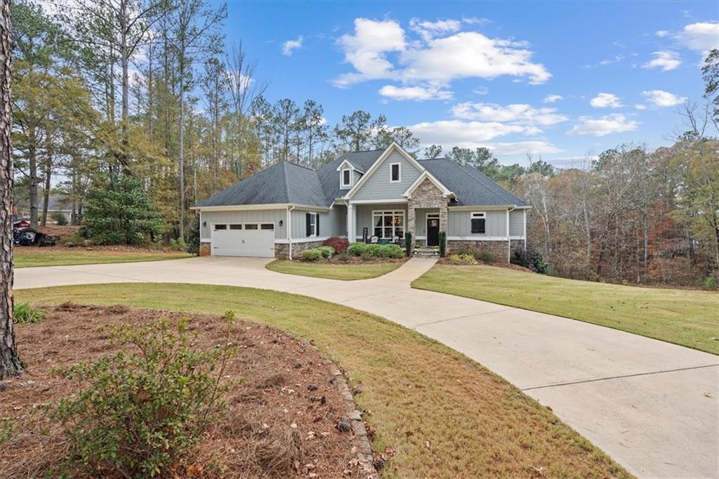 a view of house with outdoor space and sitting area