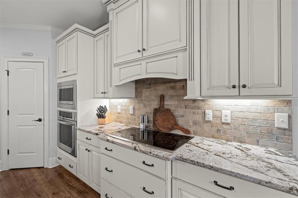 5330 North Helton Road Winston, GA 30187 - Photo 19 of 65 a kitchen with granite countertop white cabinets and white appliances