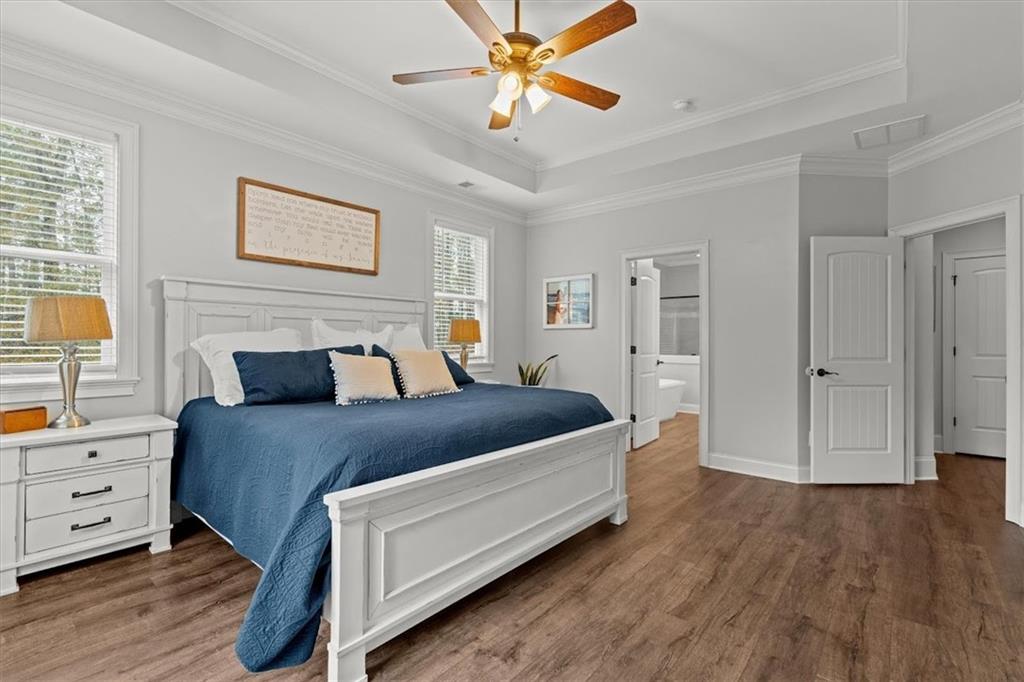 5330 North Helton Road Winston, GA 30187 - Photo 32 of 65 a spacious bedroom with a bed and a chandelier