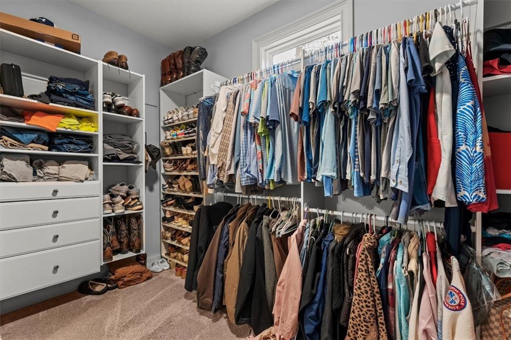 5330 North Helton Road Winston, GA 30187 - Photo 37 of 65 a view of walk in closet with clothes and shoes