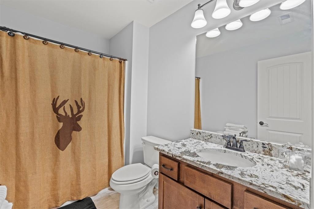 5330 North Helton Road Winston, GA 30187 - Photo 41 of 65 a bathroom with a granite countertop sink and a mirror