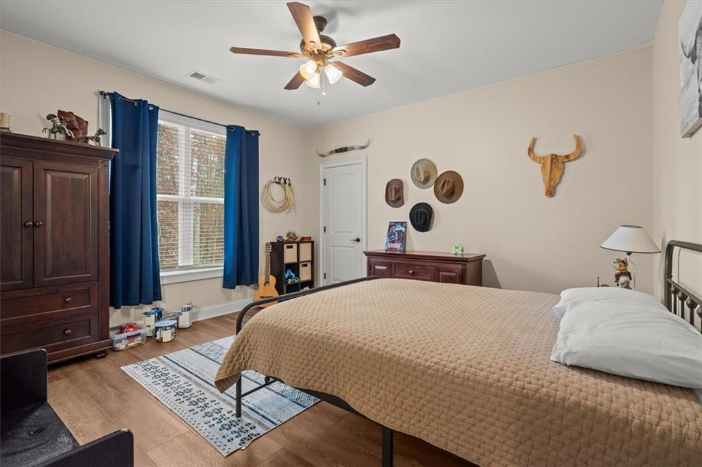 5330 North Helton Road Winston, GA 30187 - Photo 42 of 65 a bedroom with a large bed dresser and a window