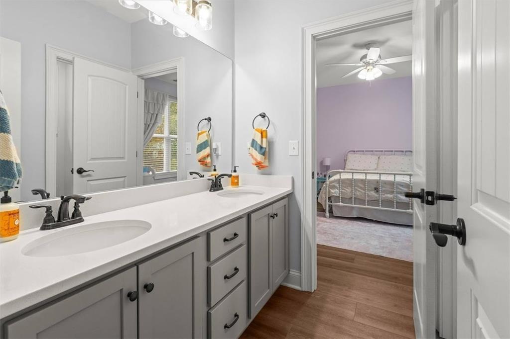 5330 North Helton Road Winston, GA 30187 - Photo 45 of 65 a en suite bathroom with a double vanity sink and a mirror