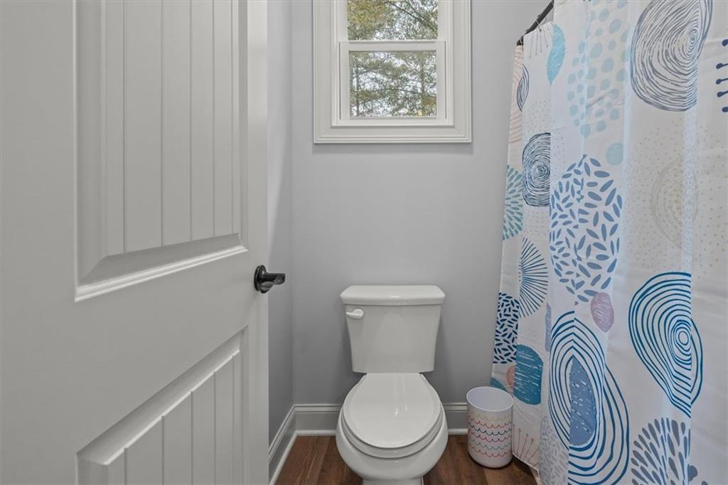 5330 North Helton Road Winston, GA 30187 - Photo 46 of 65 a white toilet sitting next to a shower curtain