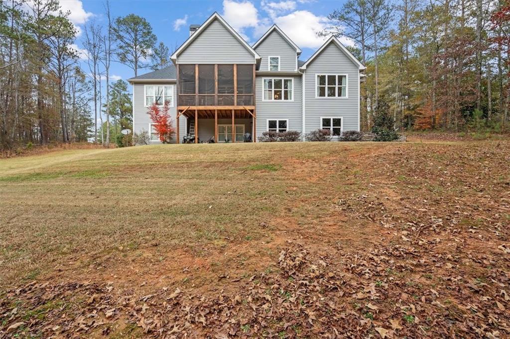 5330 North Helton Road Winston, GA 30187 - Photo 60 of 65 a view of a white house with a large trees next to a yard