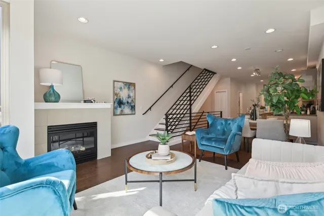 a living room with furniture a fireplace and a potted plant
