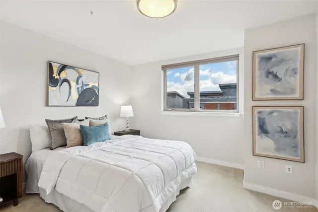 a bedroom with a bed and glass wall painting on the wall