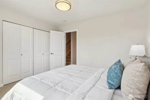 a bedroom with a bed and a lamp