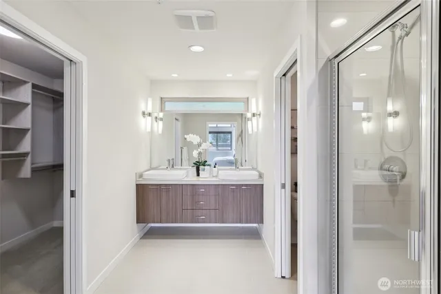 a bathroom with a bathtub shower sink and mirror
