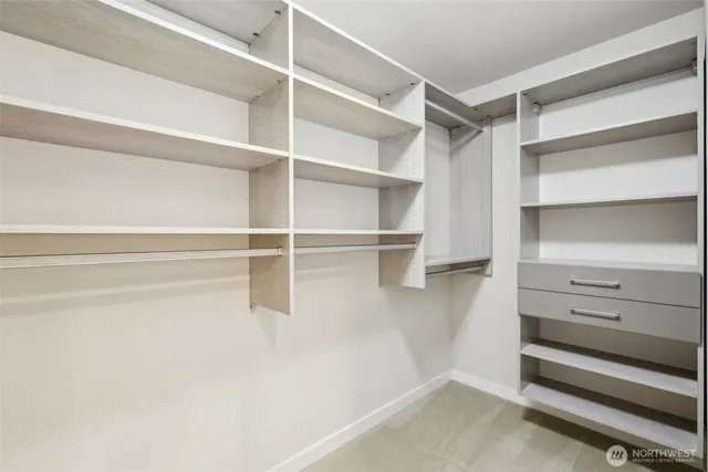 a view of walk in closet with empty racks