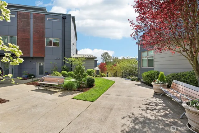 a front view of a house with a yard and seating space