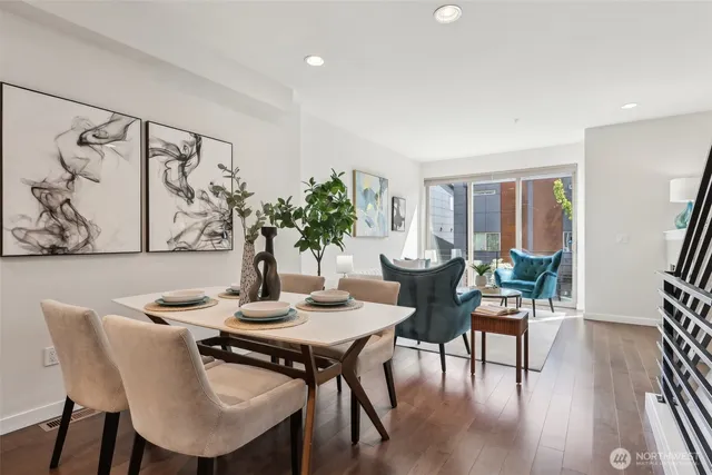 a dining room with furniture and wooden floor