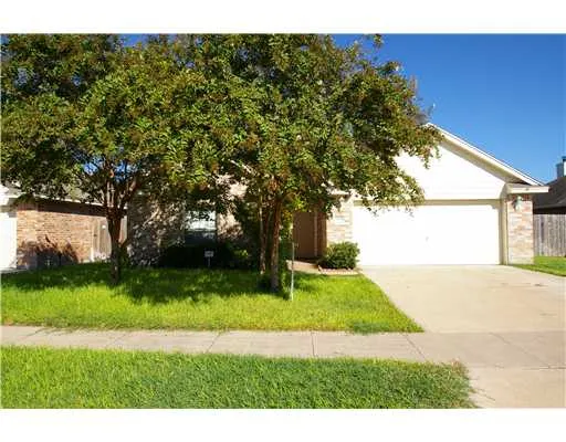 a view of an empty room with kitchen view