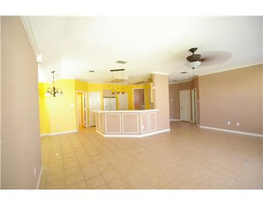 a open kitchen with a sink refrigerator and cabinets