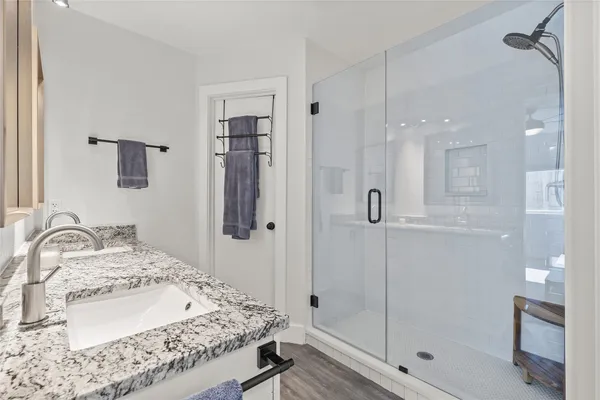 a bathroom with a sink toilet and shower