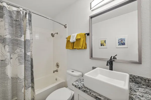 a bathroom with a toilet sink and shower