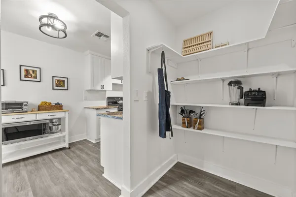 a kitchen with a refrigerator and a stove top oven