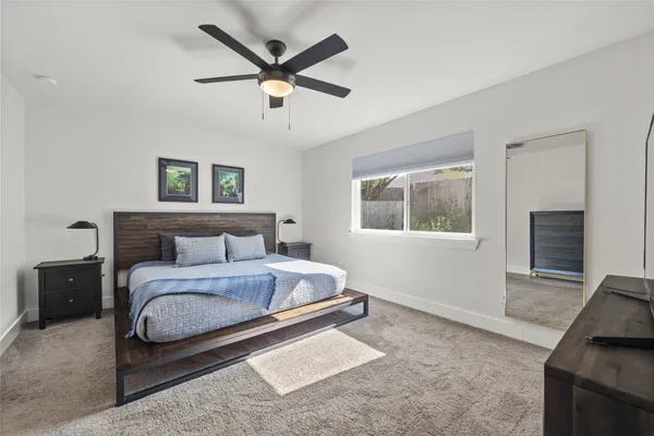 a spacious bedroom with a large bed and a window